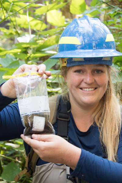 OSU Undergraduate student Meagan White displays a preserved sample of aquatic insects collected with a Surber sampler
